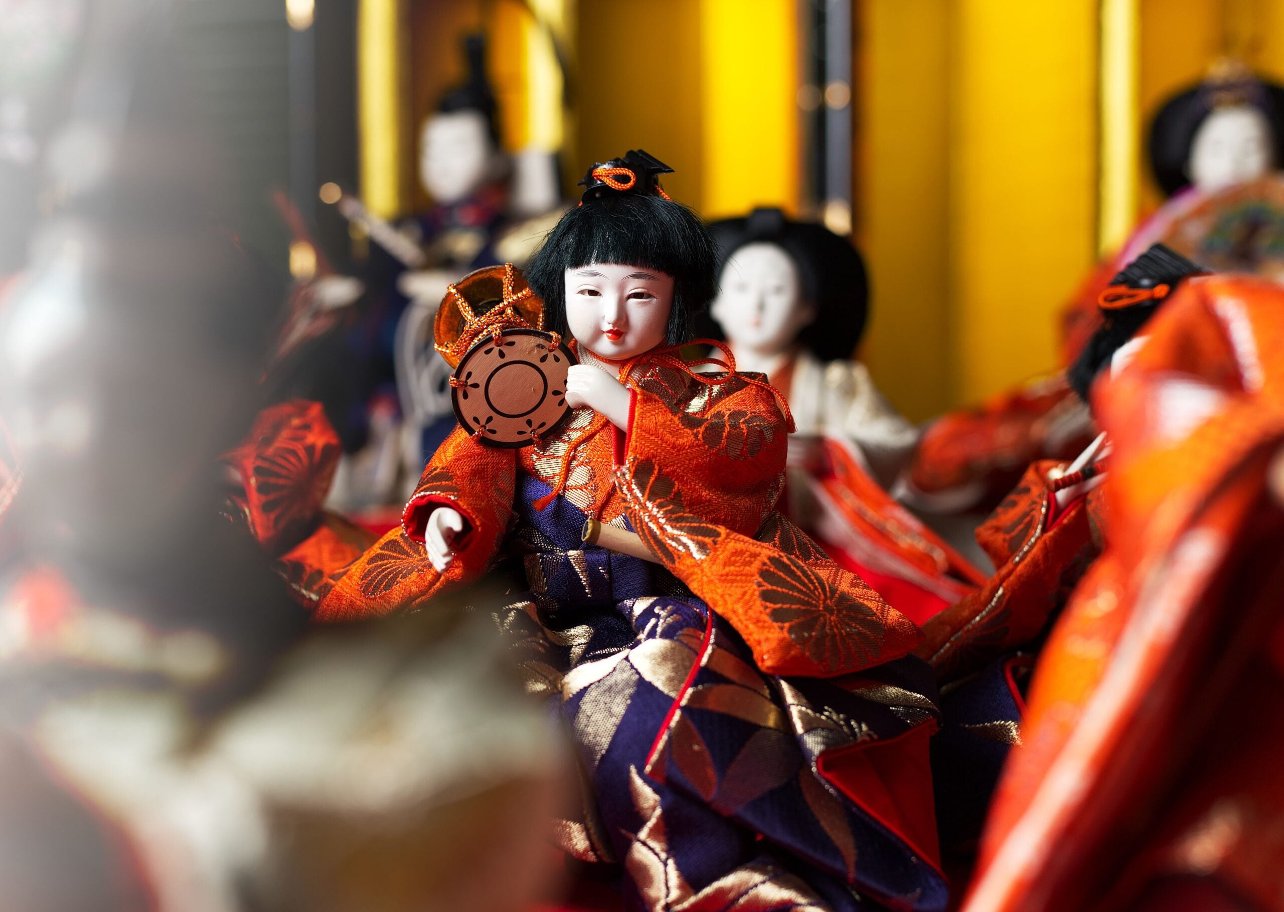 Colorful close-up of traditional Japanese dolls in kimono attire, used in the Hinamatsuri festival.