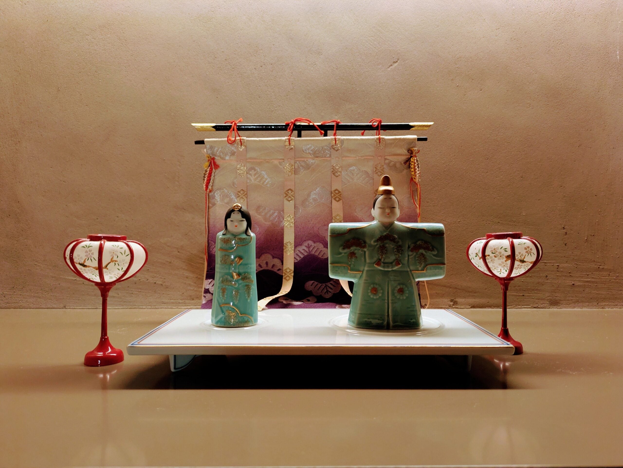 Detailed display of Japanese Hina dolls and lanterns showcasing traditional cultural decor.