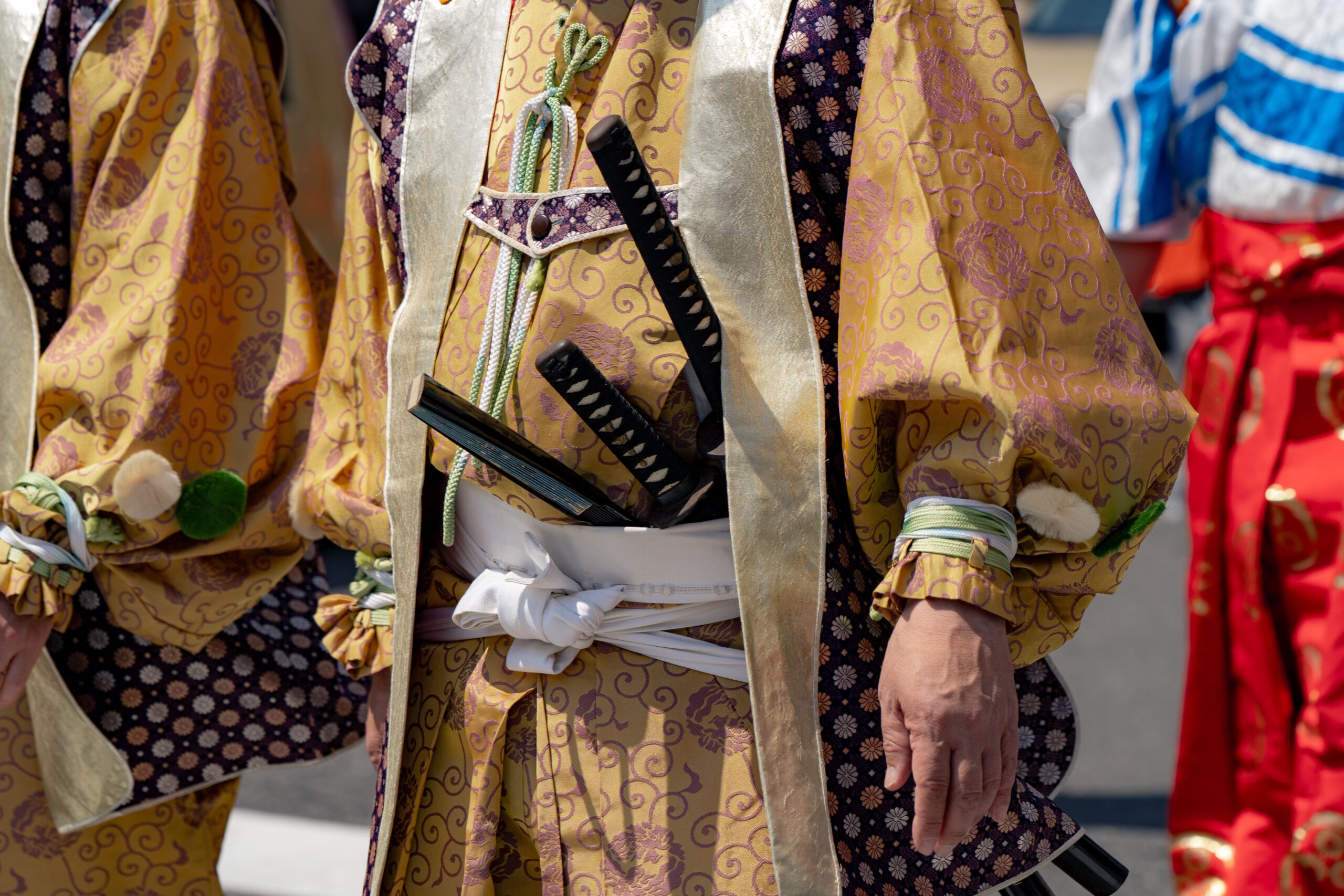 Close-up of traditional Japanese festival costumes and swords, vibrant colors in Tokyo, Japan.